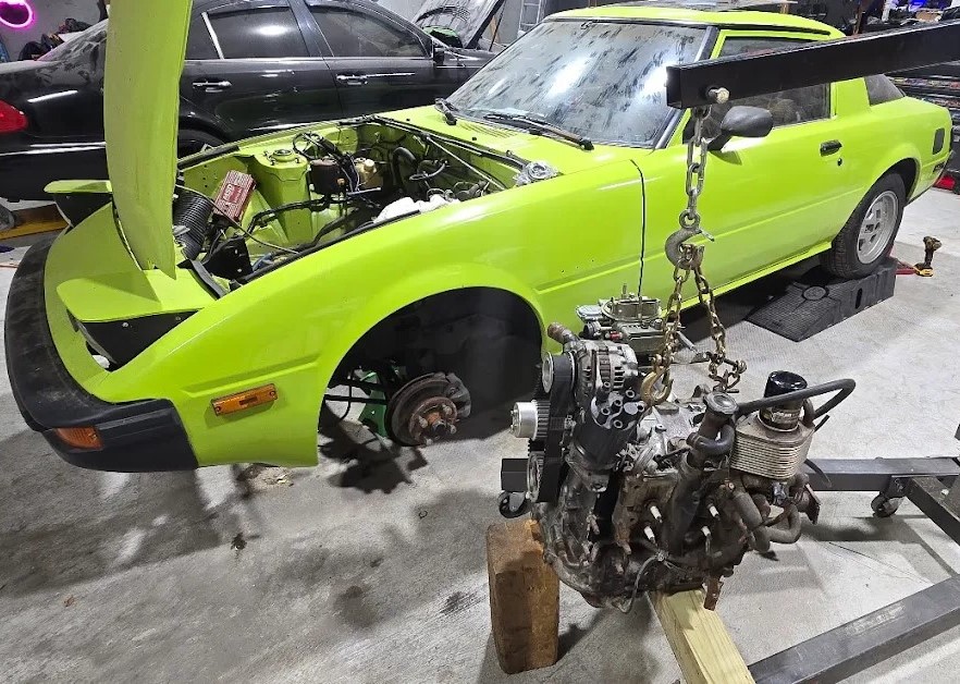 Abstract Autoz — engine swap in progress on a Mazda RX-7